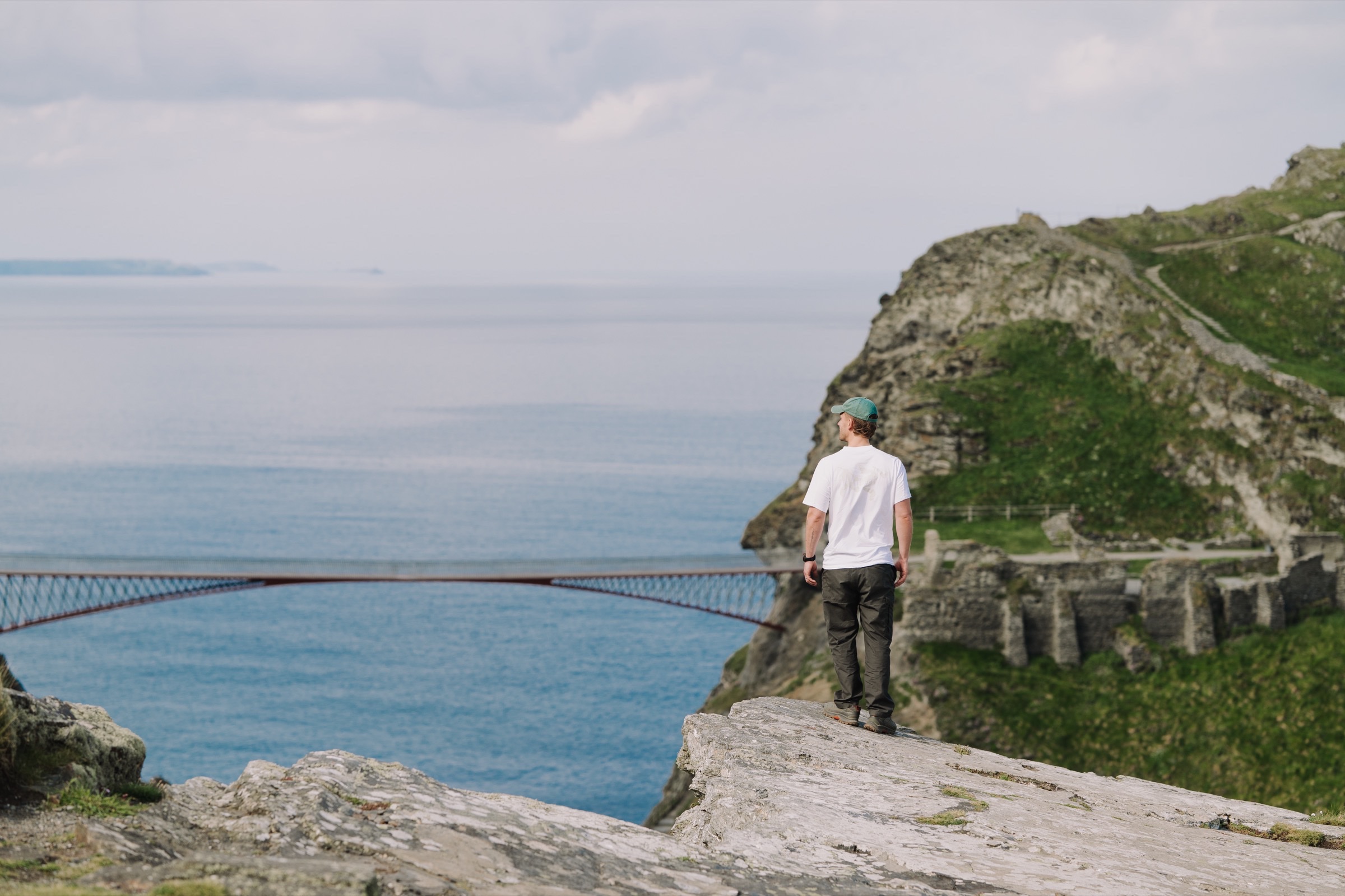 Walker on the Cornish coast path at golden hour