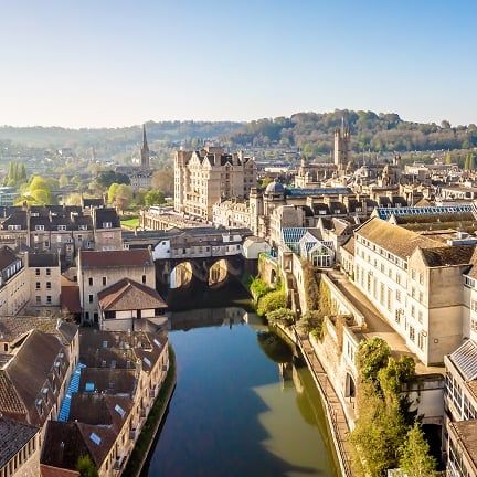 Bath from above, Pulteney Bridge spanning the River Avon with the hills beyond the city