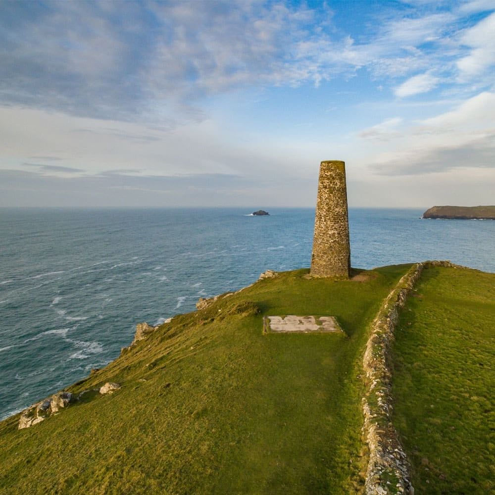 The stone daymark tower on Stepper Point, the grassy headland running out to the Atlantic