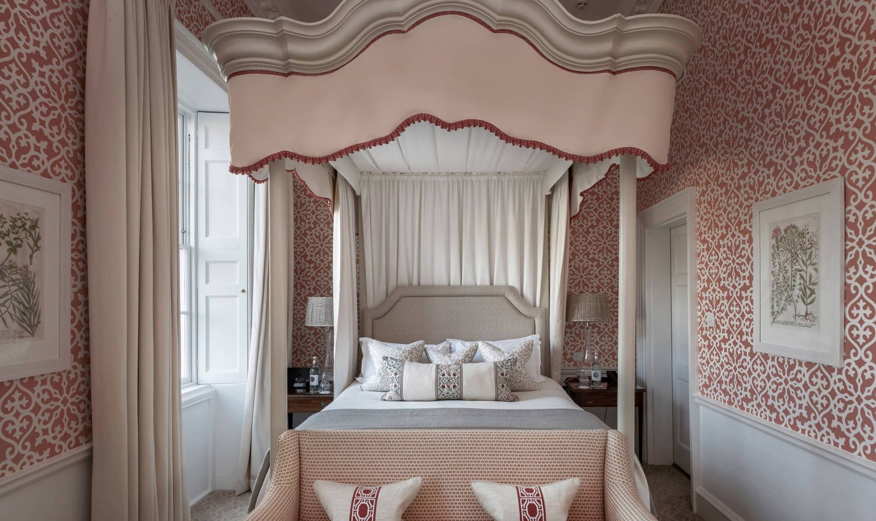 A bedroom at The Royal Crescent Hotel with a canopied four-poster bed and patterned wallpaper